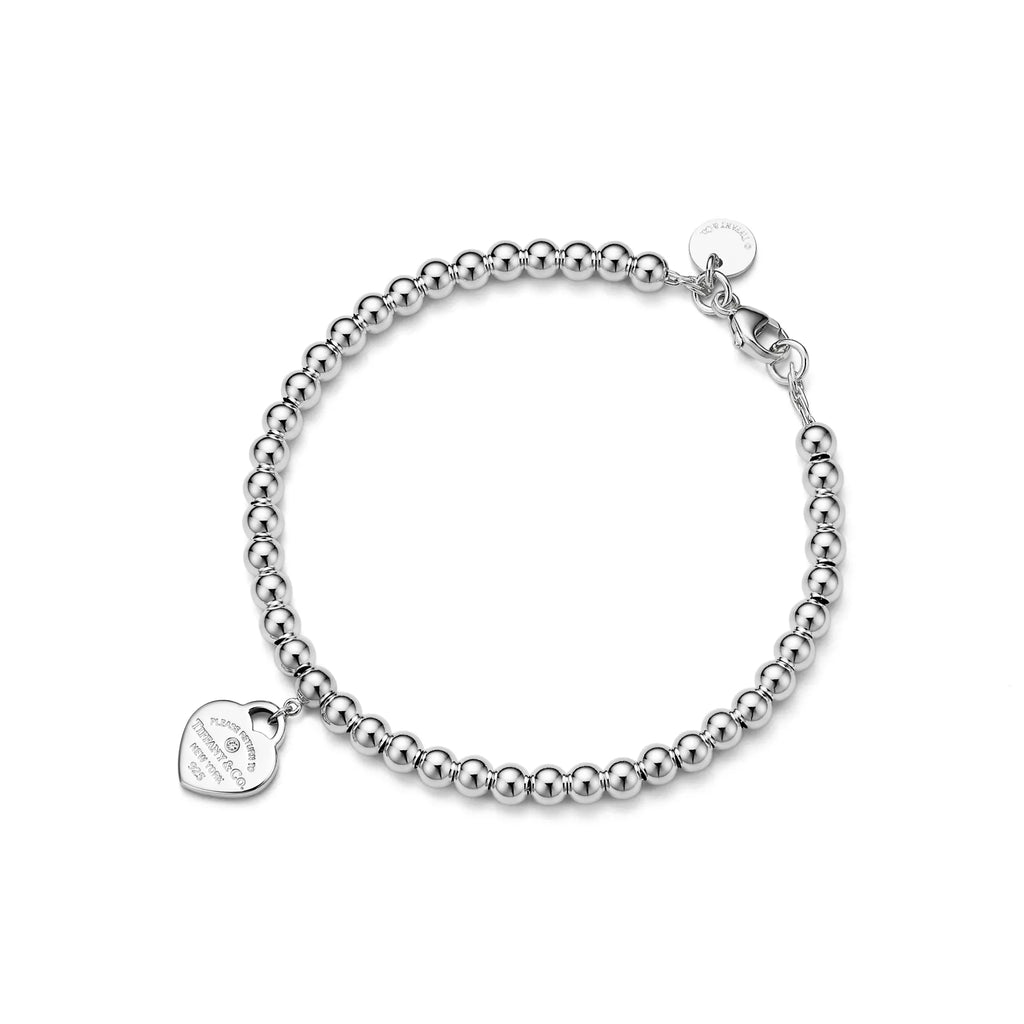 Tiffany & Co.: Pink Mini Heart Bead Bracelet in Silver with a Diamond, 4 mm